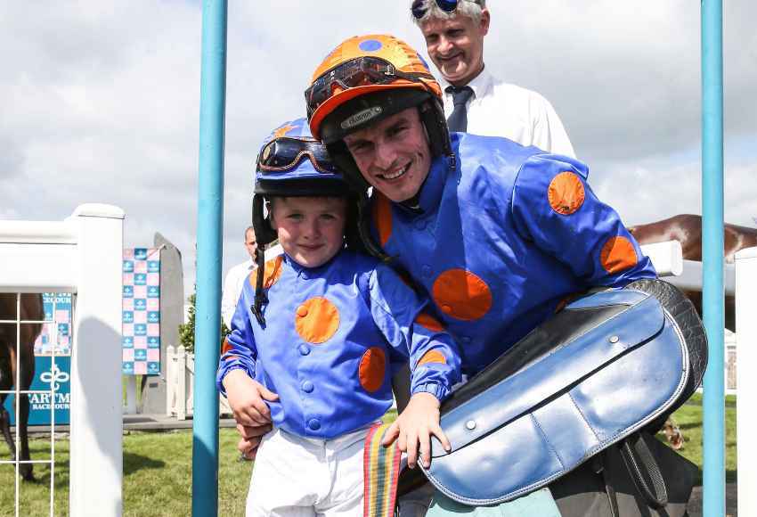 Danny Mullins poses with child at races