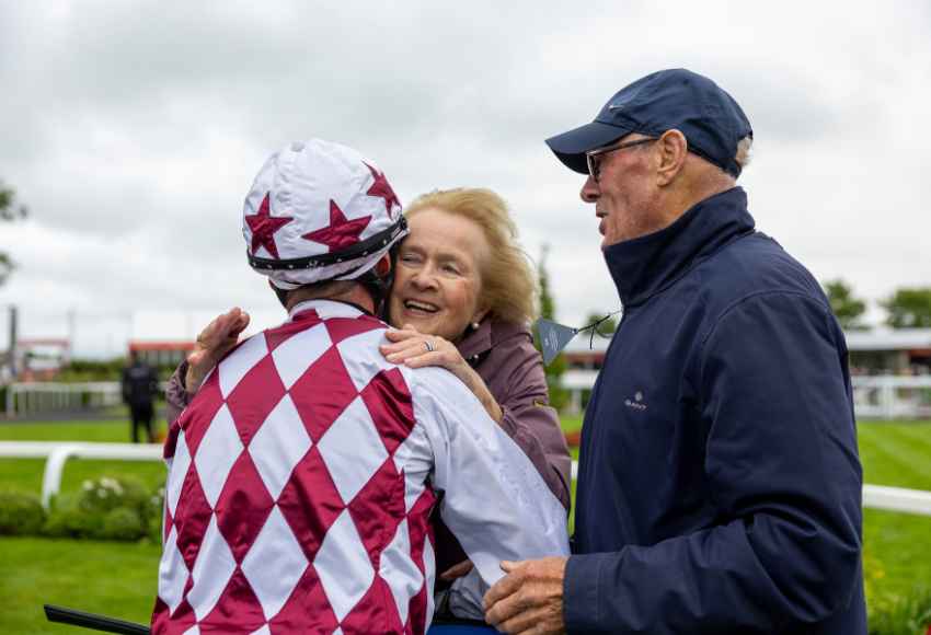 Winning owner hugging jockey